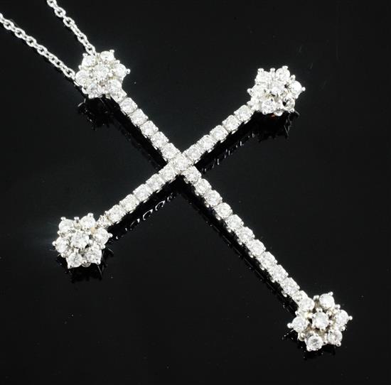 A modern white gold and diamond set cross pendant on and 18ct white gold chain, pendant 61mm.